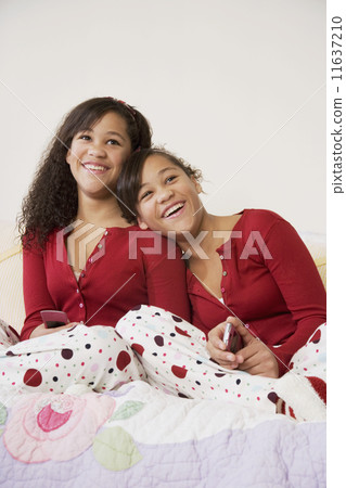 African twin sisters hugging 11637210