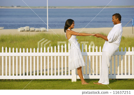 Couple holding hands at beach 11637251