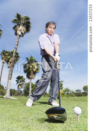 Asian man swinging golf club 11637253