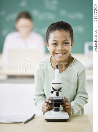 Mixed Race girl next to microscope Mixed Race girl next to microscope 11637269