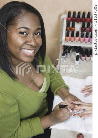 African woman performing manicure African woman performing manicure 11637308