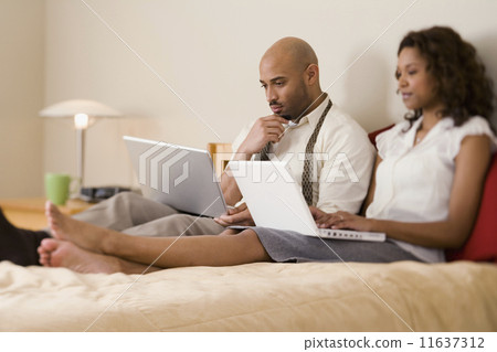 African couple typing on laptops African couple typing on laptops 11637312