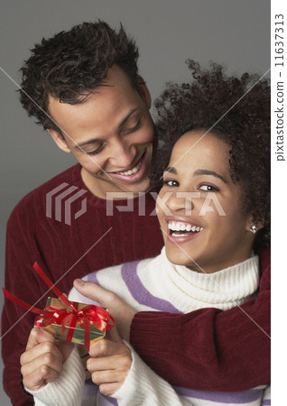 Young couple with gift Young couple with gift 11637313
