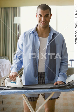 Hispanic businessman ironing pants 11637353