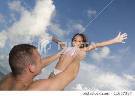 Father holding daughter in air Father holding daughter in air 11637354