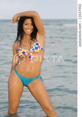 Hispanic woman wearing bikini in water 11637402