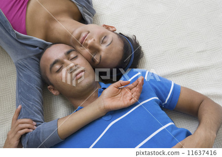 Young couple laying with heads touching Young couple laying with heads touching 11637416