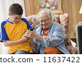 Young boy and his grandfather fighting over the remote control 11637422