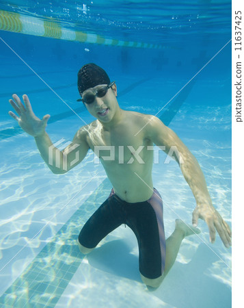 Underwater shot of Asian man waving 11637425