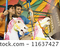Couple riding a rollercoaster 11637427