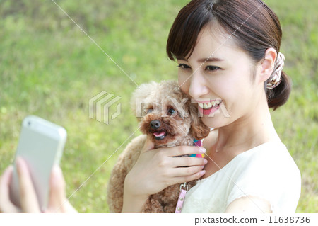Dog and young woman and mobile phone 11638736