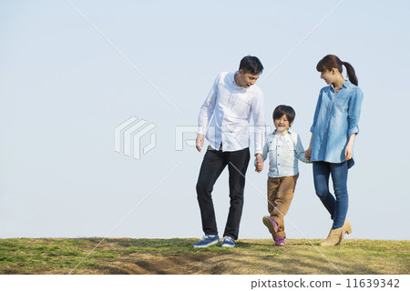 Parent and child walking under blue sky Parent and child walking under blue sky 11639342