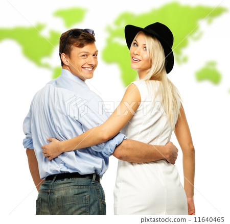 Beautiful smiling young couple against world map Beautiful smiling young couple against world map 11640465