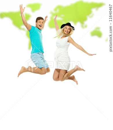 Beautiful smiling young couple jumping against world map Beautiful smiling young couple jumping against world map 11640467