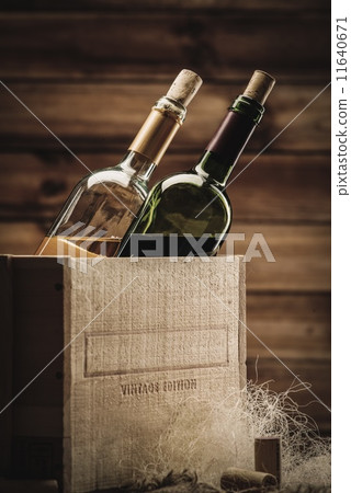 Bottle of red and white wine in wooden box 11640671
