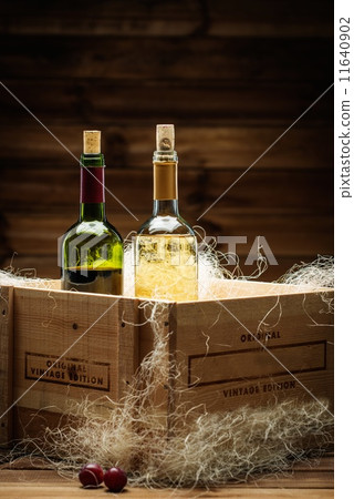 Bottle of red and white wine in wooden box Bottle of red and white wine in wooden box 11640902