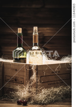 Bottle of red and white wine in wooden box Bottle of red and white wine in wooden box 11640903