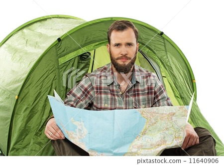 Handsome traveler in a tent with a map planning route Handsome traveler in a tent with a map planning route 11640906