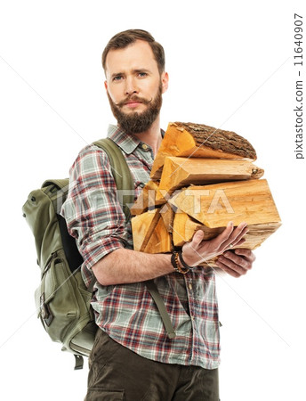 Handsome traveler with backpack and logs for bonfire Handsome traveler with backpack and logs for bonfire 11640907