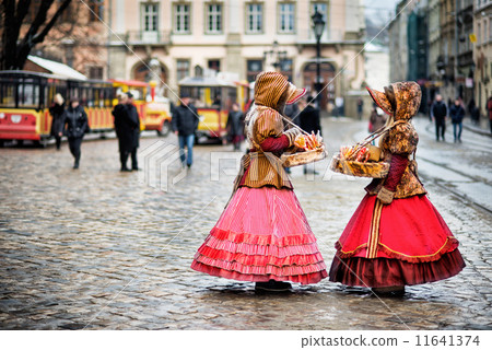 two woman in traditional clothes standing in the square in old city Lvov 11641374