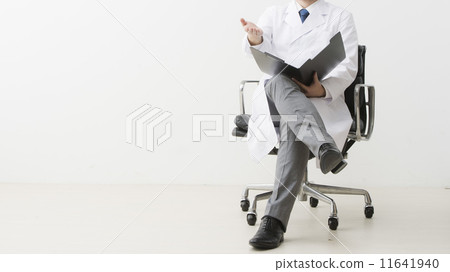 A man in a white robe looking at documents A man in a white robe looking at documents 11641940