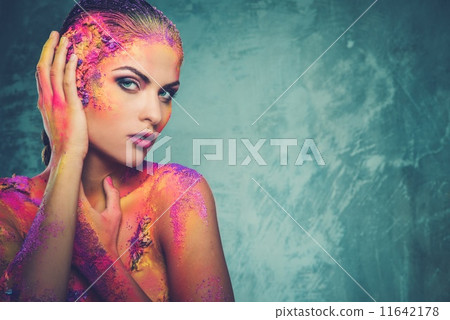 Beautiful young woman with conceptual colourful body art 11642178