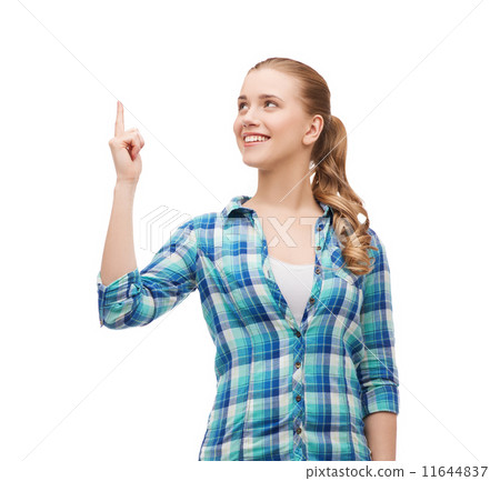 smiling young woman pinting finger up smiling young woman pinting finger up 11644837