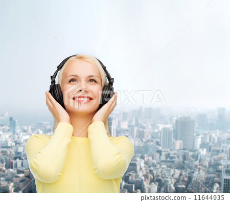 smiling young woman with headphones smiling young woman with headphones 11644935
