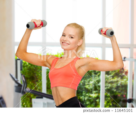 smiling beautiful sporty woman with dumbbells smiling beautiful sporty woman with dumbbells 11645101