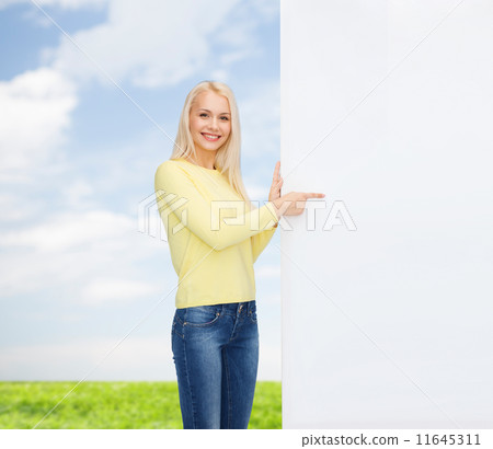 smiling woman in sweater with blank white board 11645311