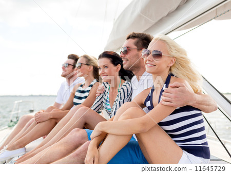 smiling friends sitting on yacht deck smiling friends sitting on yacht deck 11645729