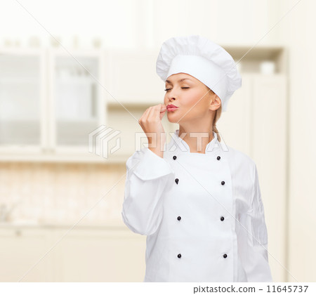 smiling female chef showing delicious sign 11645737