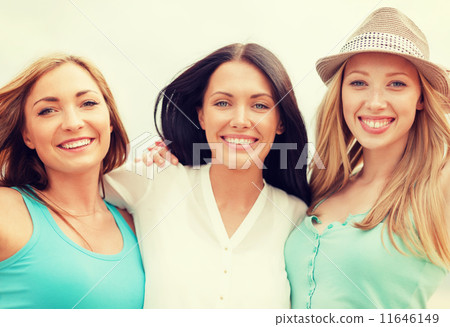 group of smiling girls chilling on the beach 11646149