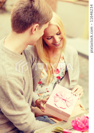 romantic happy couple with gift in the cafe romantic happy couple with gift in the cafe 11646234