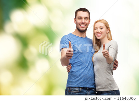 smiling couple showing thumbs up smiling couple showing thumbs up 11646300