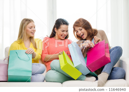 smiling teenage girls with many shopping bags 11646940