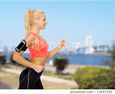 sporty woman running with smartphone and earphones sporty woman running with smartphone and earphones 11647245