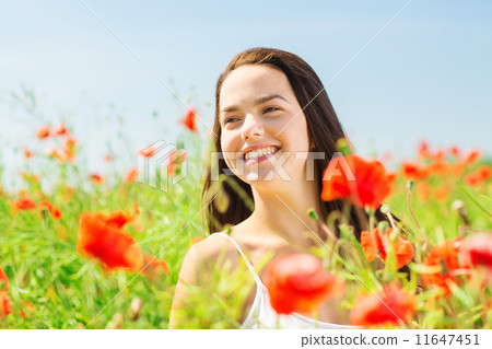smiling young woman on poppy field 11647451