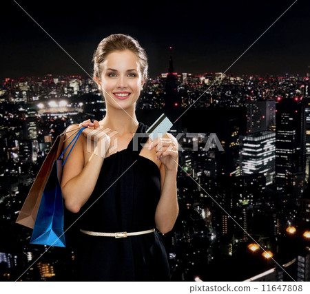 smiling woman with shopping bags and credit card smiling woman with shopping bags and credit card 11647808