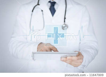 male doctor holding tablet pc with medical app male doctor holding tablet pc with medical app 11647809