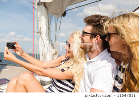 smiling friends sitting on yacht deck smiling friends sitting on yacht deck 11647811