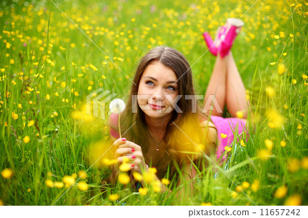 woman blow on dandelion woman blow on dandelion 11657242