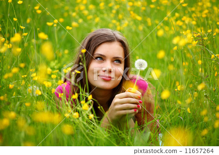 woman blow on dandelion 11657264