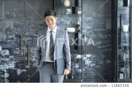 Young Asian business man smiling Young Asian business man smiling 11665338