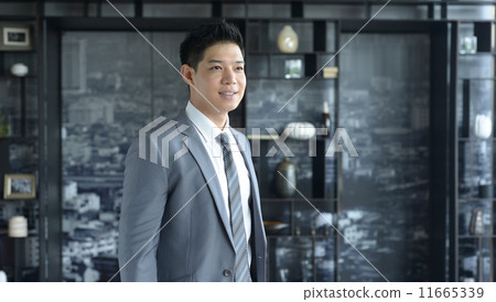 Young Asian business man smiling Young Asian business man smiling 11665339