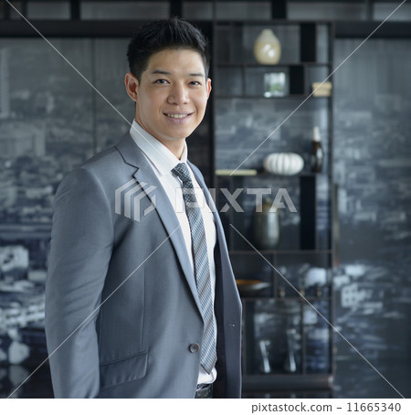 Young Asian business man smiling Young Asian business man smiling 11665340