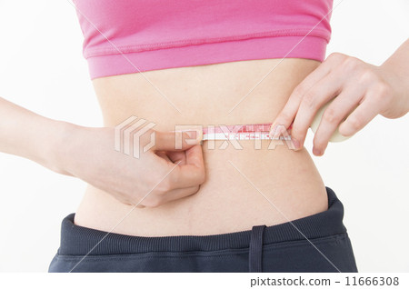 Young woman measuring waist size Diet slender 11666308