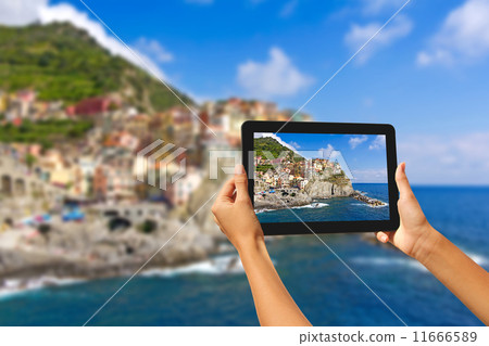 Girl taking pictures on a tablet in Manorola Girl taking pictures on a tablet in Manorola 11666589