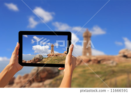 Woman taking pictures on a tablet lighthouse Woman taking pictures on a tablet lighthouse 11666591