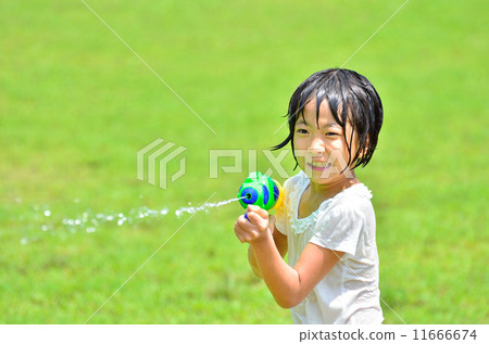 Girl playing with water gun (lawn open space) 11666674